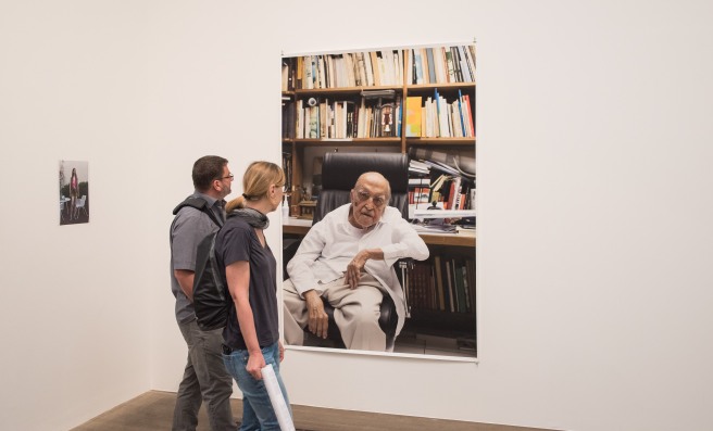 Two People Looking at a Portrait by Wolfgang Tillmans